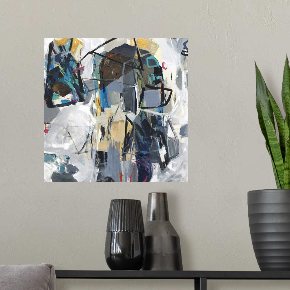 A modern room featuring Square abstract art with colorfully compiled, loose, geometric shapes surrounded by shades of gray.
