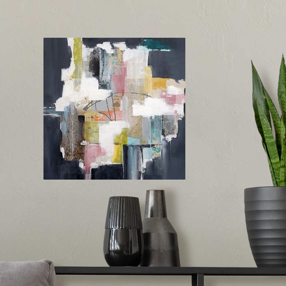 A modern room featuring Colorful abstract artwork with bright white spaces among pink, yellow, and navy blocks.
