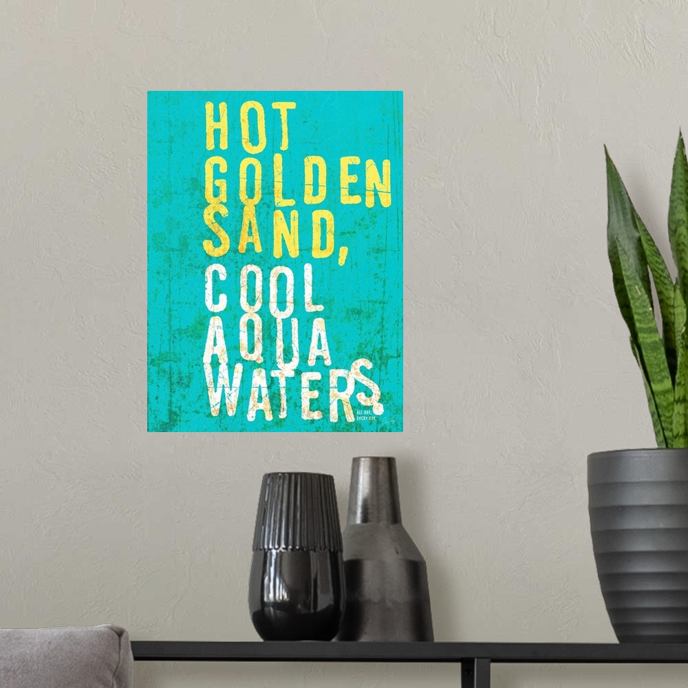 A modern room featuring Beach house looking wall art with distressed wording reading Hot golden sand, cool aqua waters on...