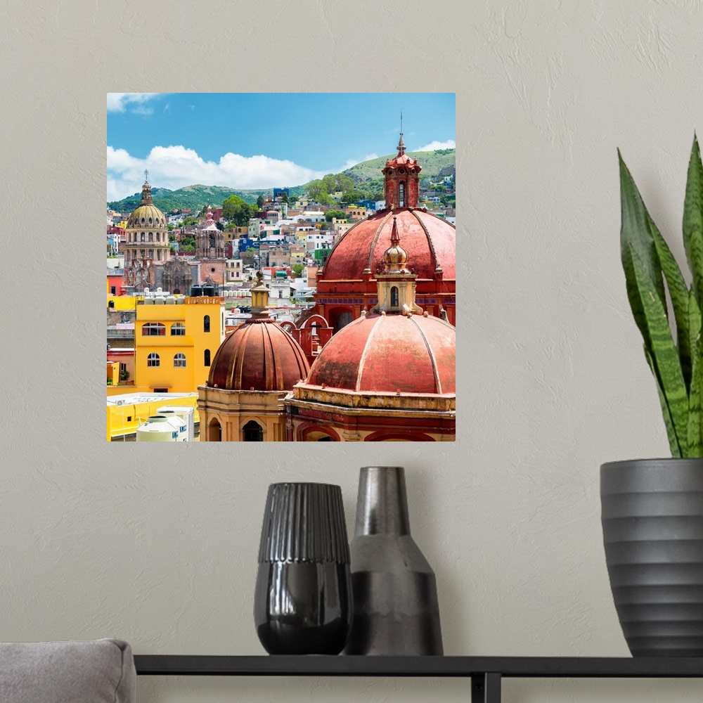 A modern room featuring Square photograph of a cityscape in Guanajuato, Mexico, highlighting the colorful buildings and c...