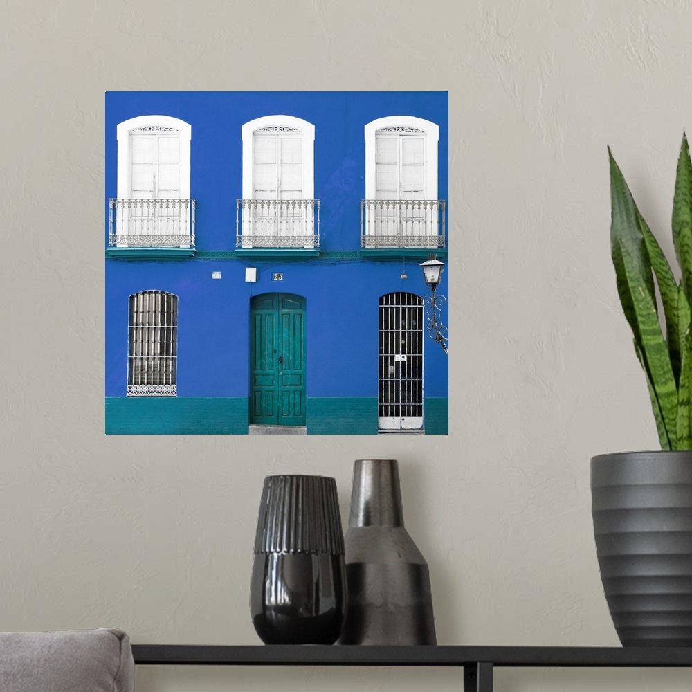 A modern room featuring It's a beautiful blue facade of an old building in Seville, Spain.