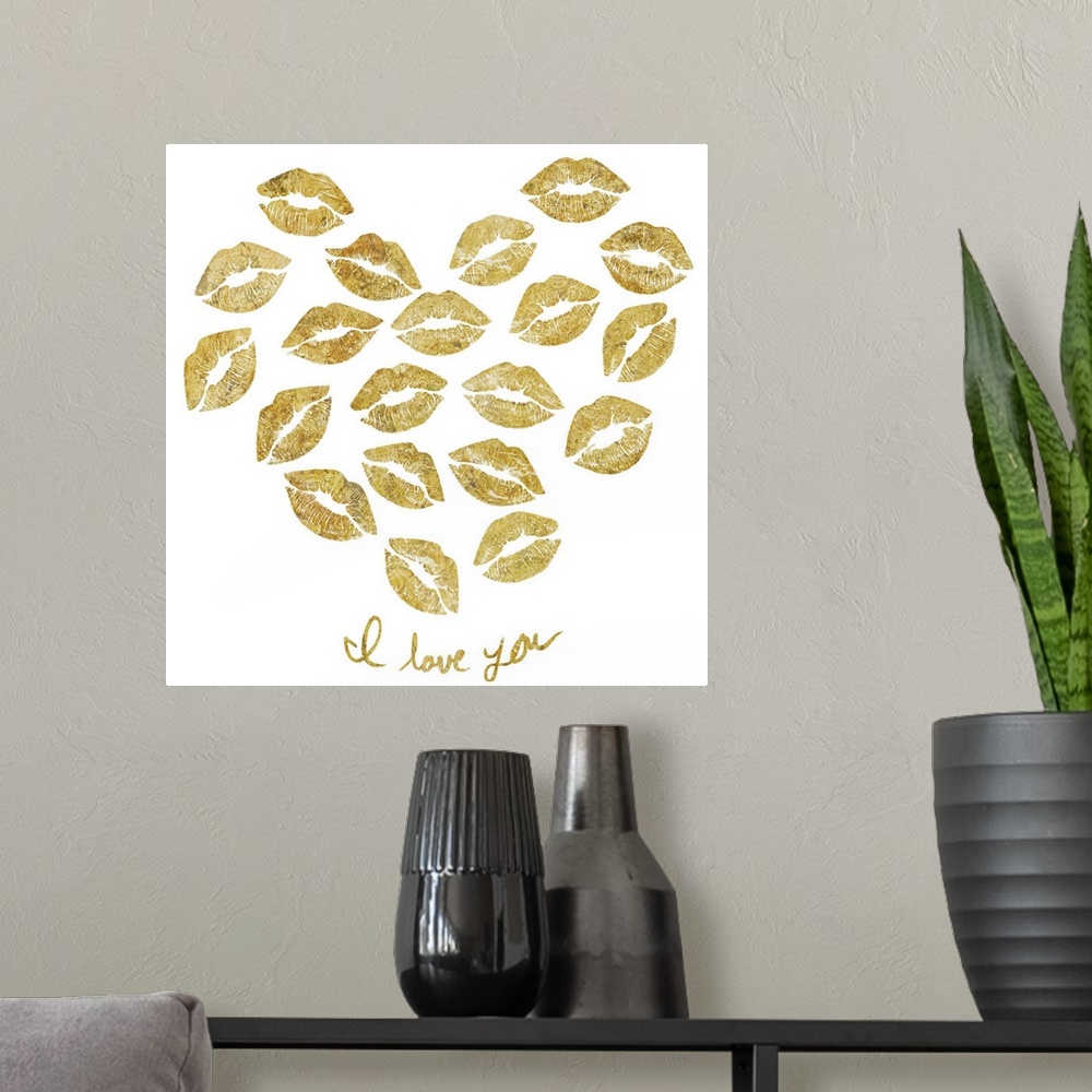 A modern room featuring Home decor artwork of gold lettering and a heart made of lip prints against a white background.