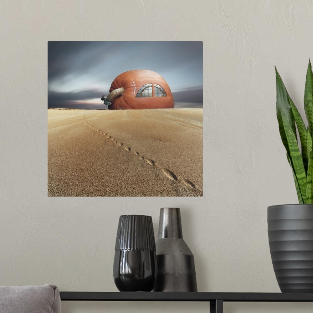 A modern room featuring Conceptual photo of a house made of a giant pumpkin in the sand.