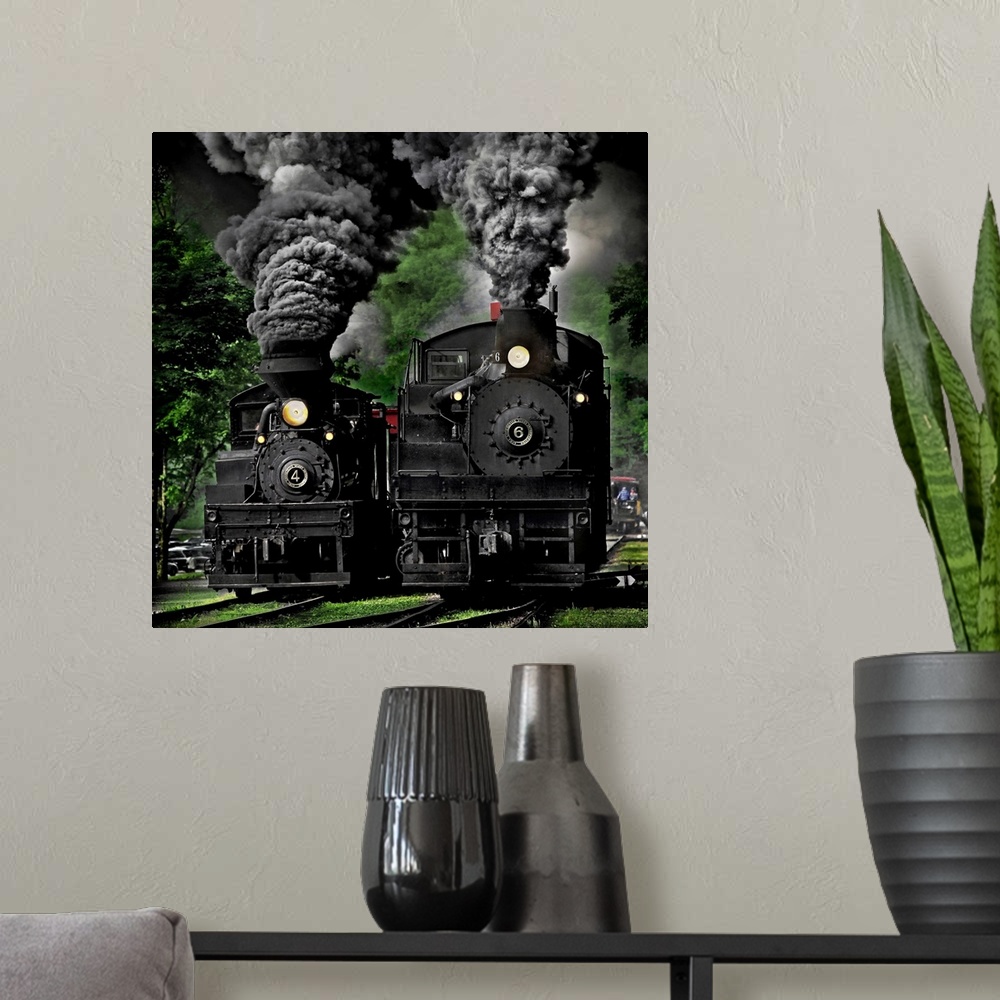 A modern room featuring Two black locomotives approaching on the railroad tracks.
