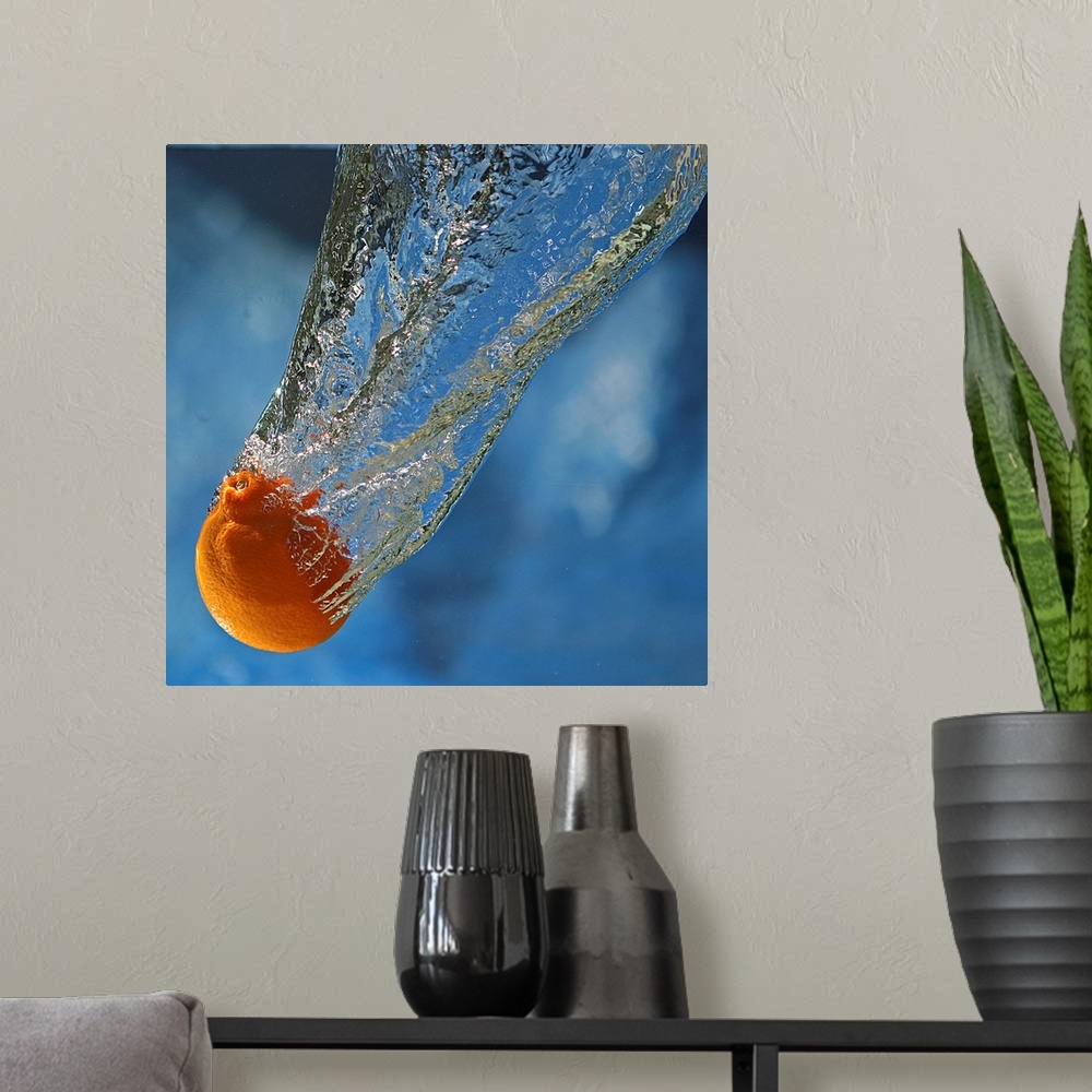 A modern room featuring A tangerine dropped in water.