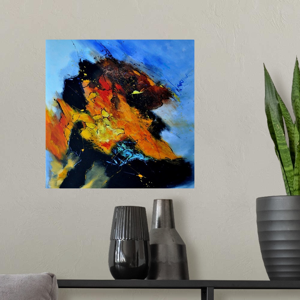 A modern room featuring Abstract painting in shades of orange, yellow, blue and red mixed in with black contrasting designs.