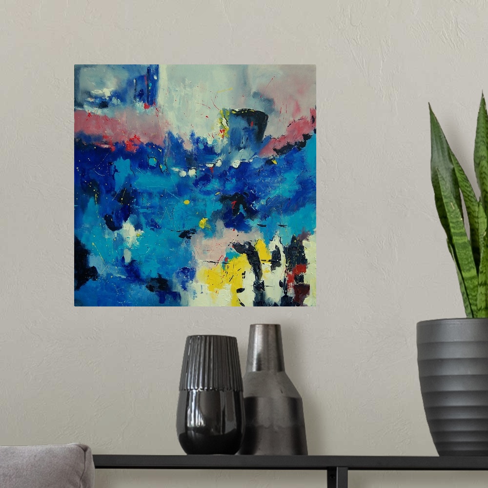 A modern room featuring A square abstract painting of colors of red, yellow and blue in textured brush strokes and splatt...