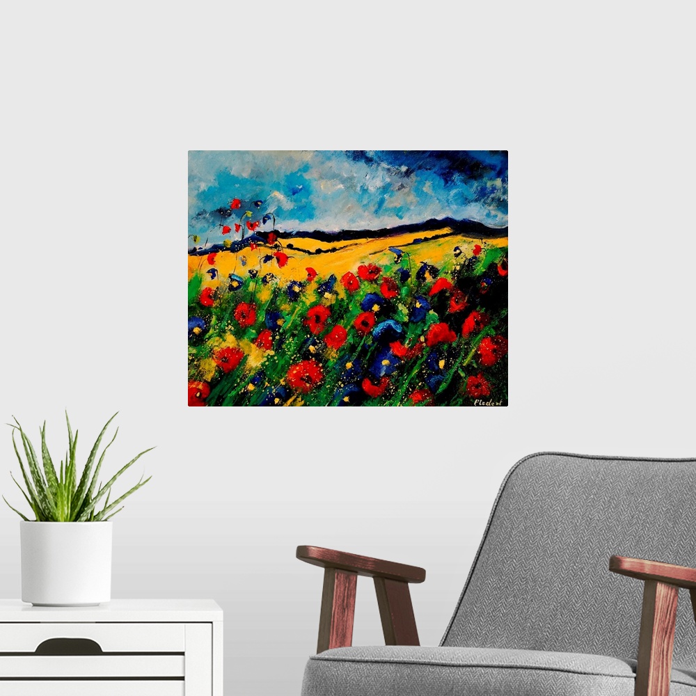 A modern room featuring Horizontal painting of a colorful landscape with red and blue poppies in the foreground and rolli...