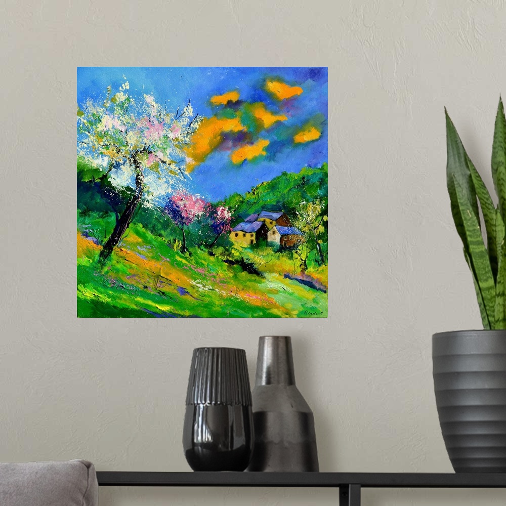A modern room featuring Vibrant painting of a bright Summer day with blossoming trees, a colorful sky, and a village in t...