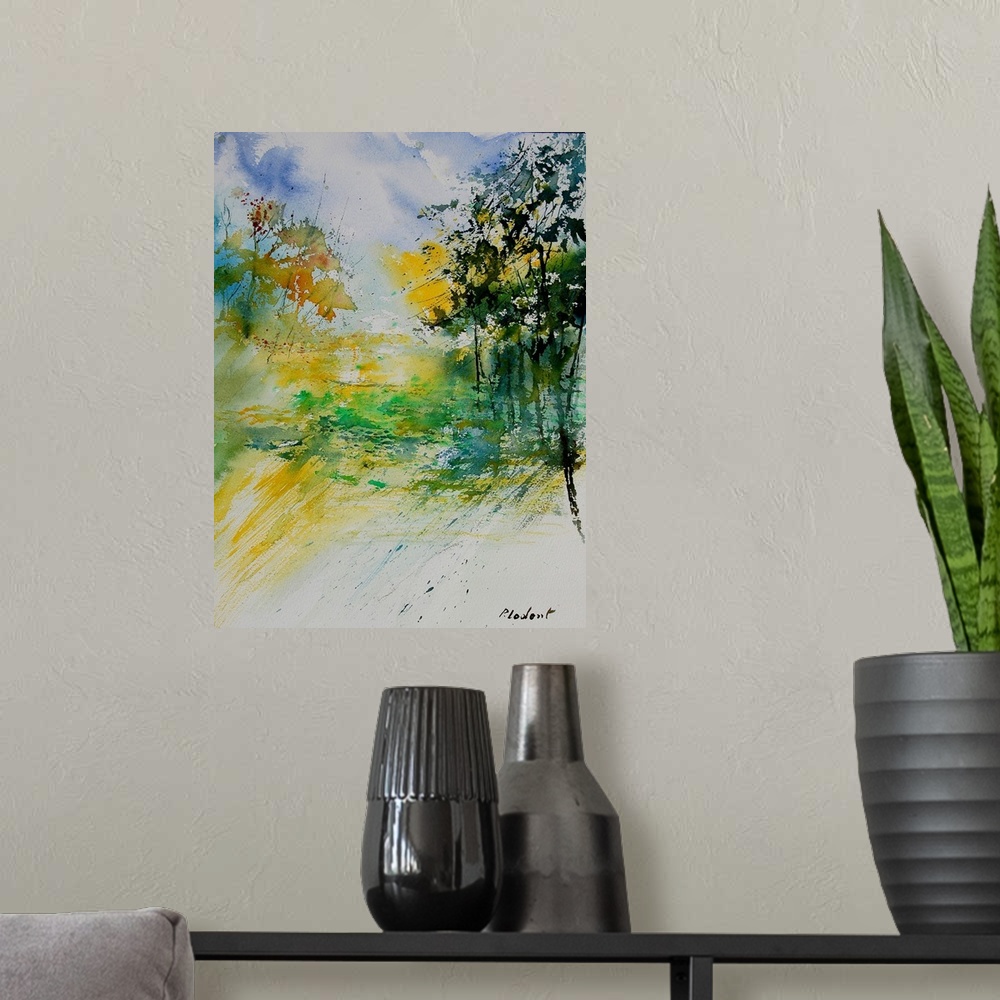 A modern room featuring A vertical watercolor landscape in bright colors of yellow, green and blue.