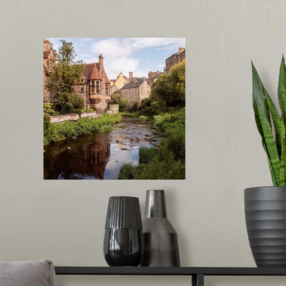 A modern room featuring Square photograph of picturesque Dean Village with Water of Leith flowing throwing through the mi...