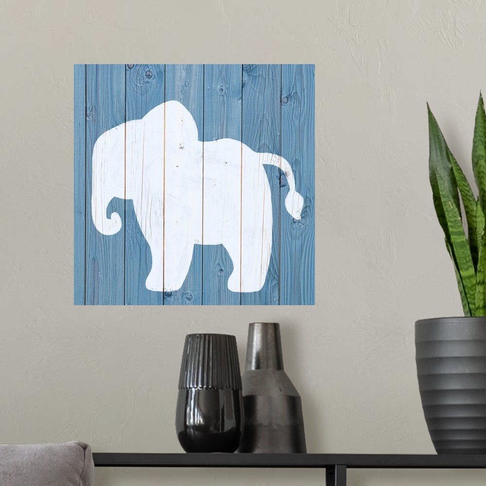 A modern room featuring Nursery art of an elephant outline painted on a blue board background.
