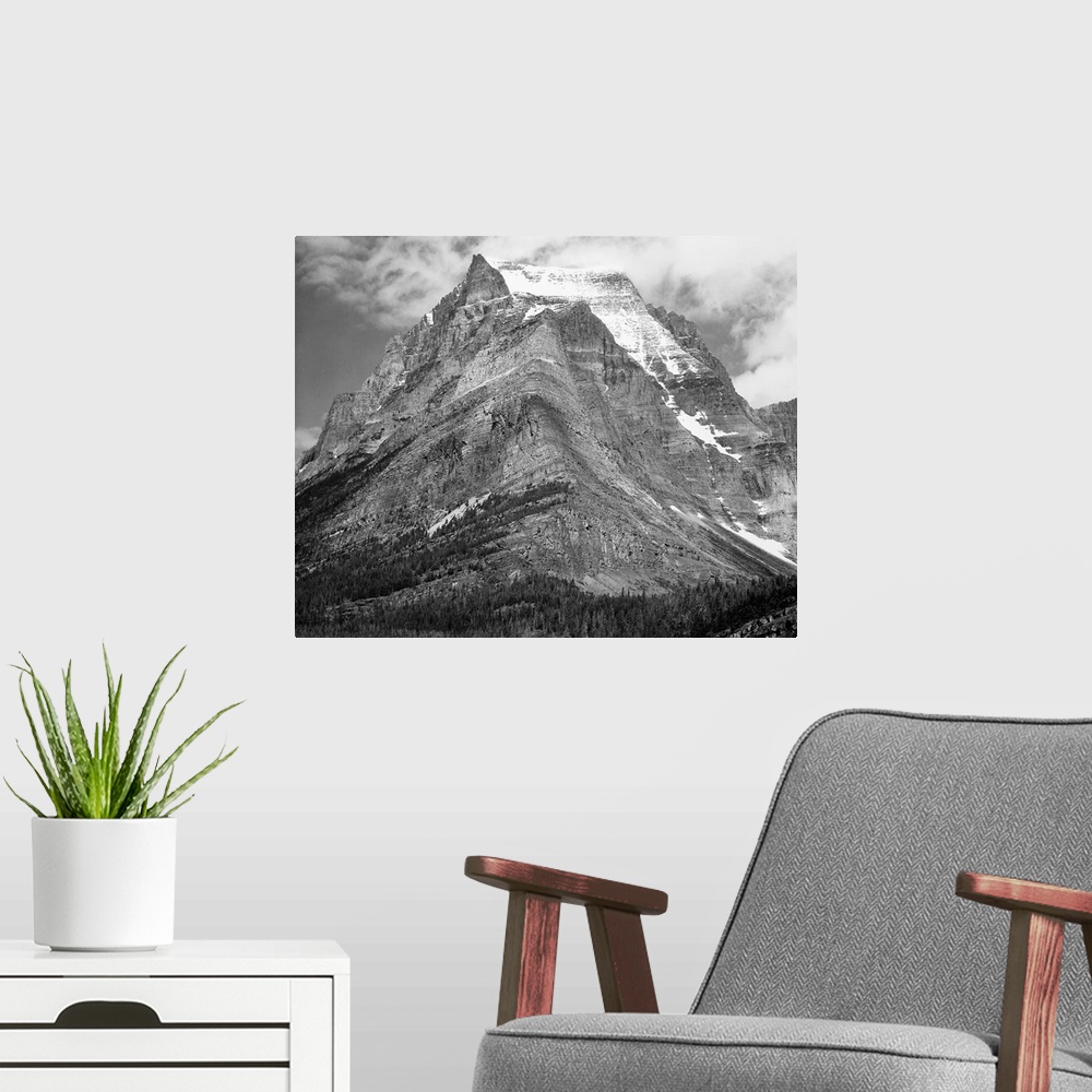 A modern room featuring Going-to-the-Sun Mountain, Glacier National Park, full view of mountain.