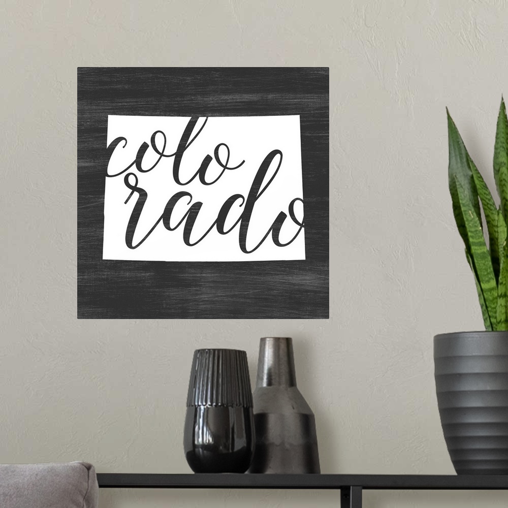 A modern room featuring Colorado state outline typography artwork.