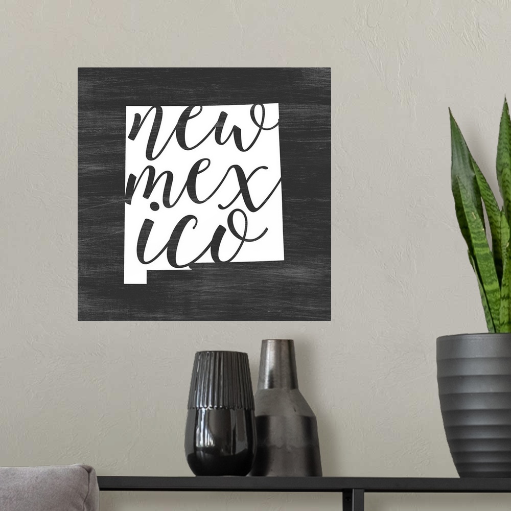 A modern room featuring New Mexico state outline typography artwork.
