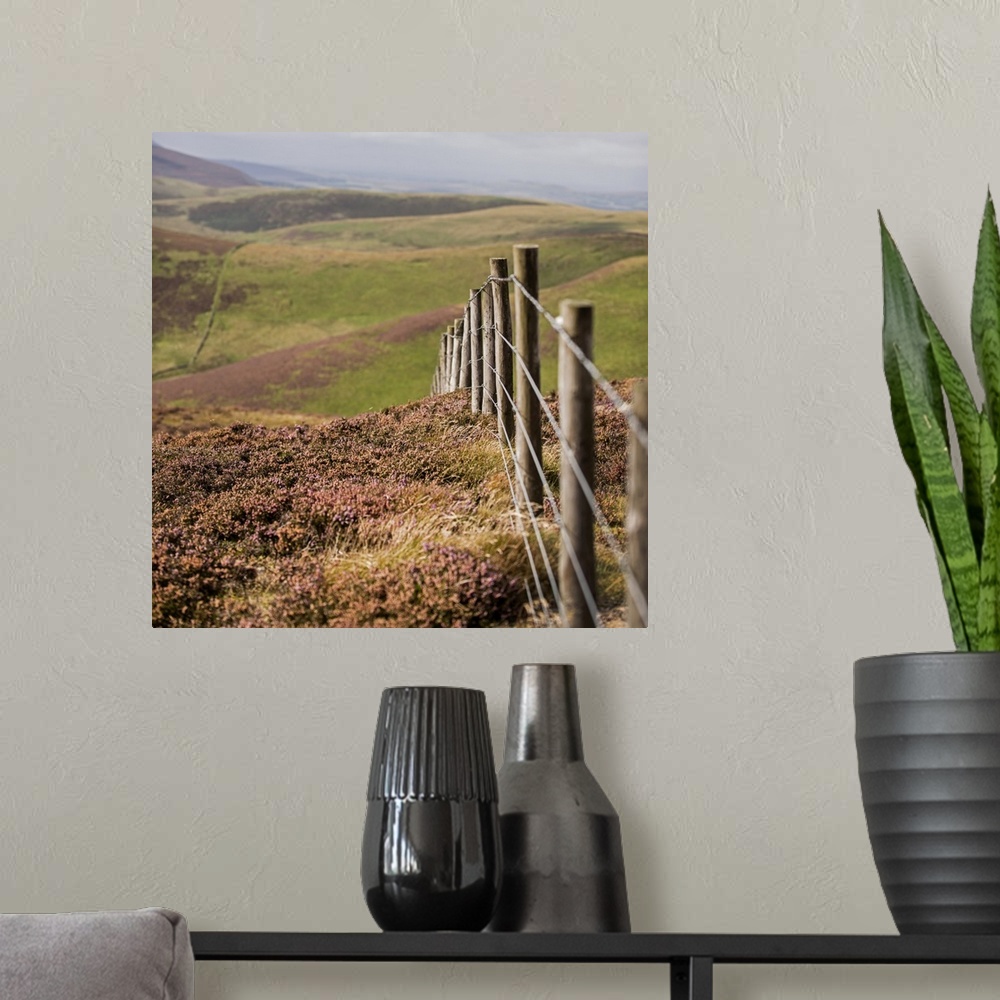 A modern room featuring Square photograph of a fence running though rolling hills in an Edinburgh countryside, Scotland, UK