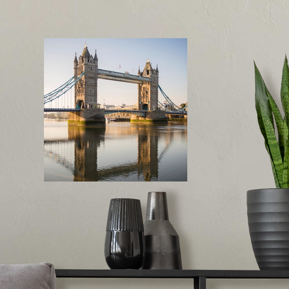 A modern room featuring Square photograph of Tower Bridge reflecting into the River Thames in London, England, UK.