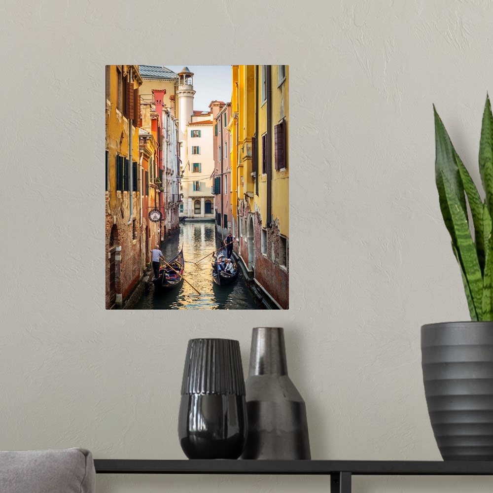 A modern room featuring Photograph of two gondolas passing each other through a canal lined with yellow and red buildings...