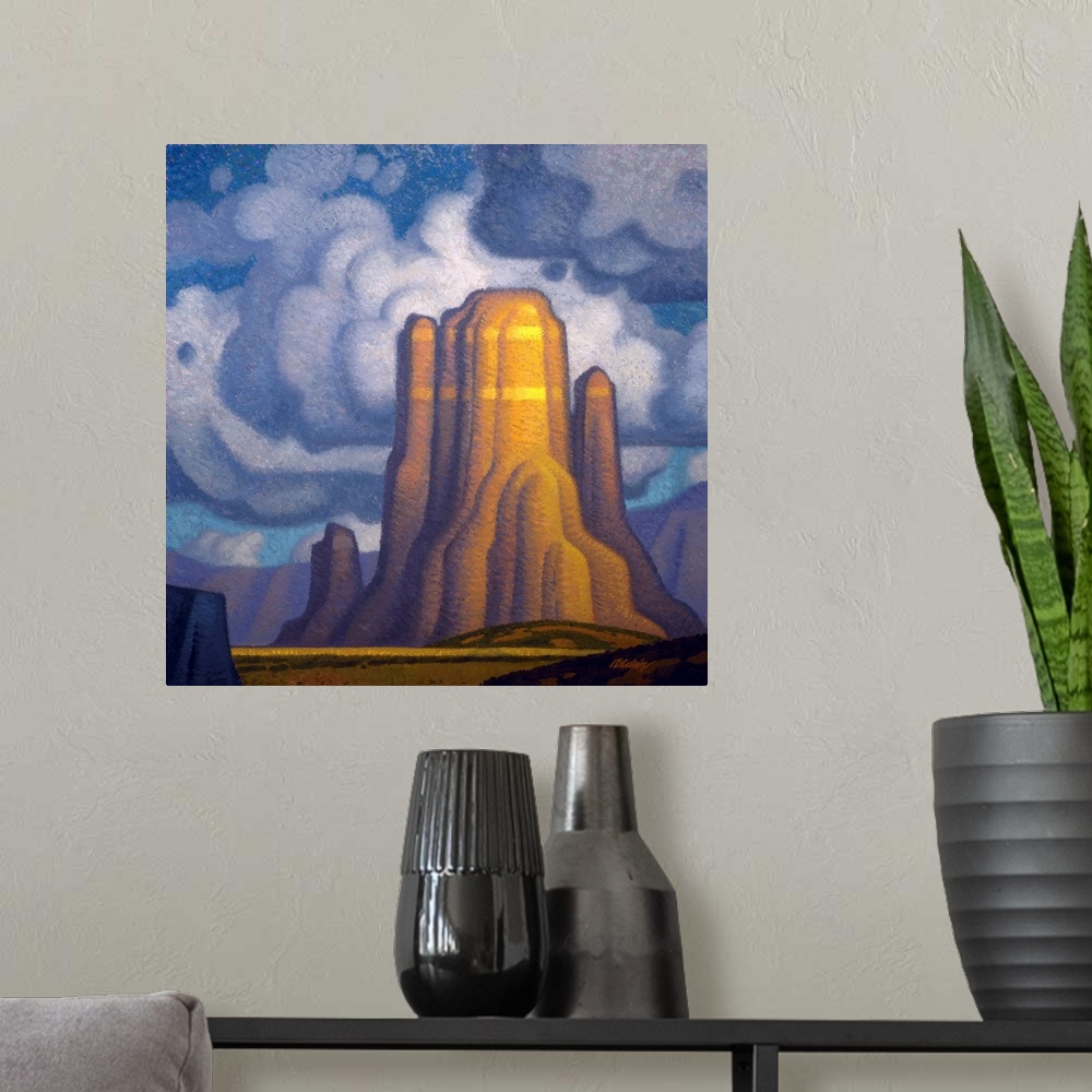 A modern room featuring Landscape painting of red rock with looming clouds.