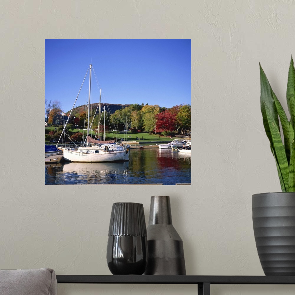 A modern room featuring Boats on waterfront at Camden harbour with Mount Battie, Maine, USA