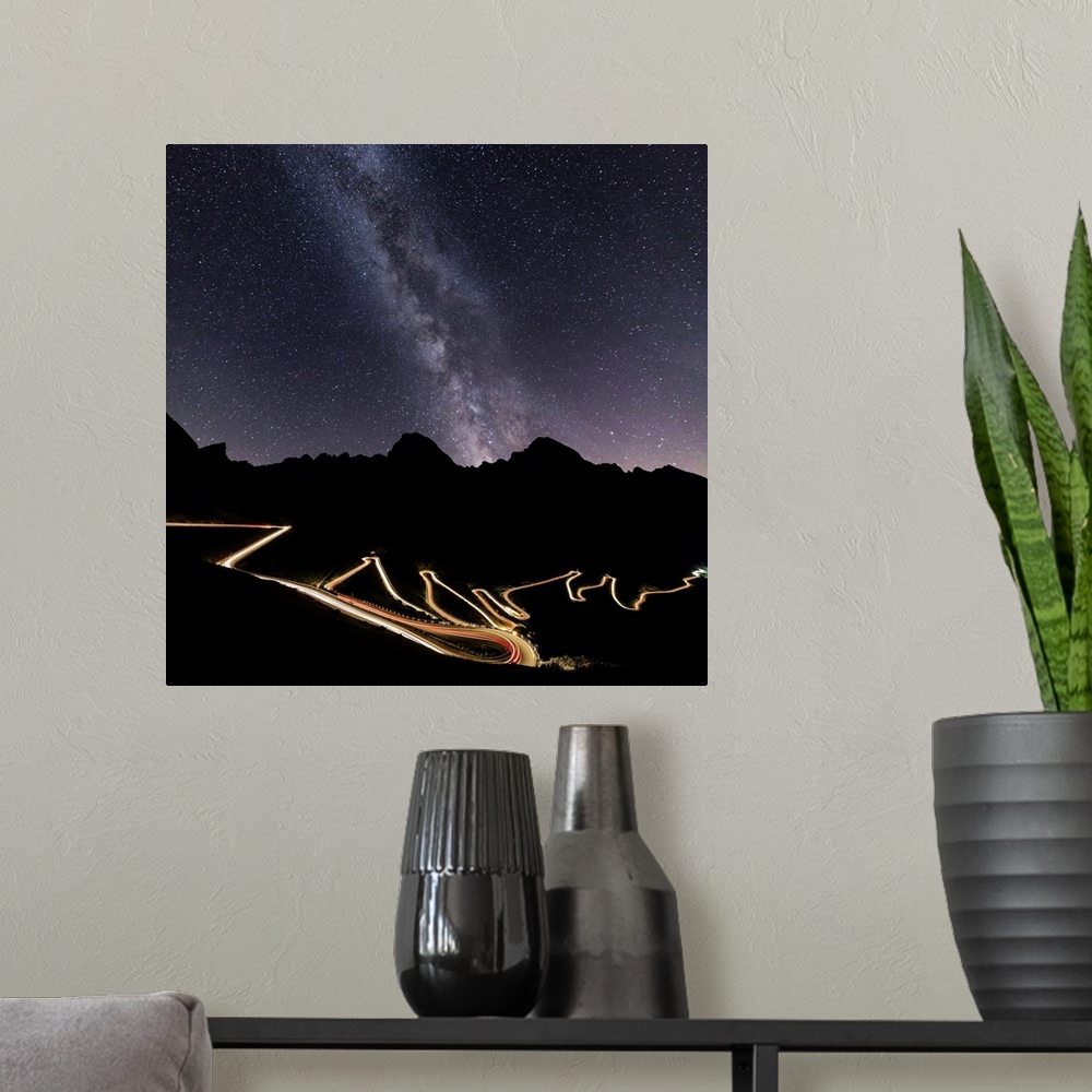 A modern room featuring Panorama of the Milky Way and lights of car trace at Stelvio Pass, Valtellina, Lombardy, Trentino...