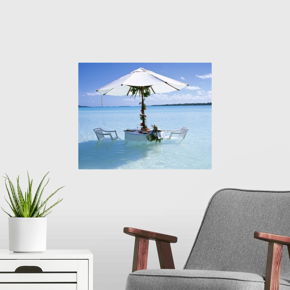 A modern room featuring Table, chairs and parasol in the ocean, Bora Bora Tahiti, French Polynesia