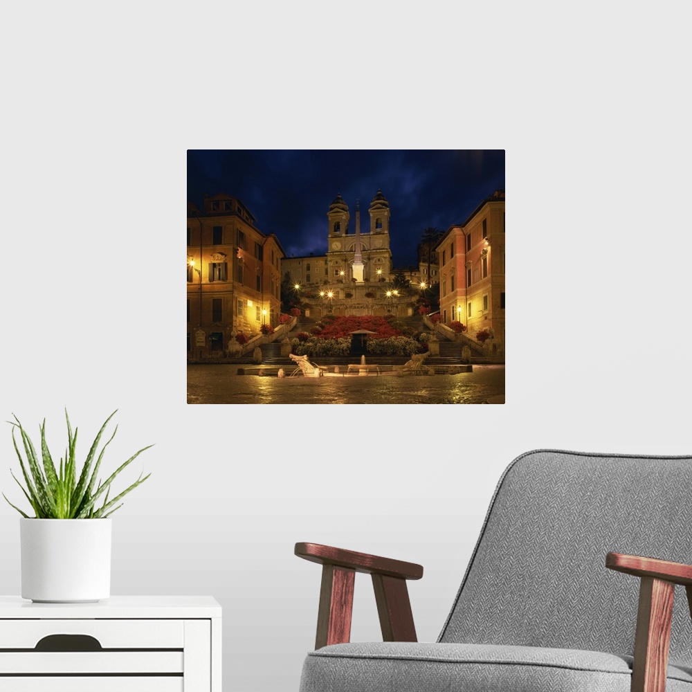 A modern room featuring The Spanish Steps illuminated at night in the city of Rome, Lazio, Italy