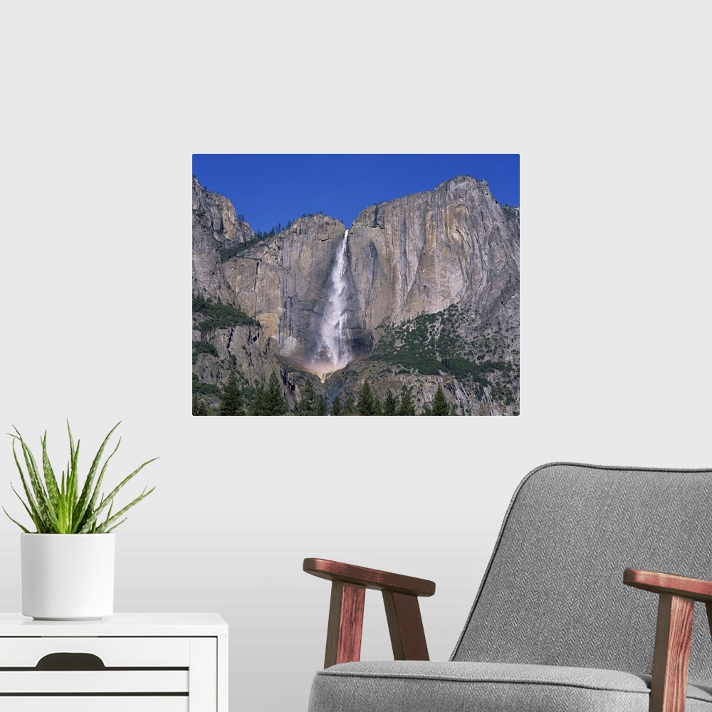 A modern room featuring Waterfall cascades over rock wall at Rainbow Falls in the Yosemite Park, California