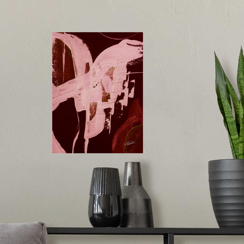 A modern room featuring Abstract painting with a bold burnt red background and brighter pink brushstrokes on top.