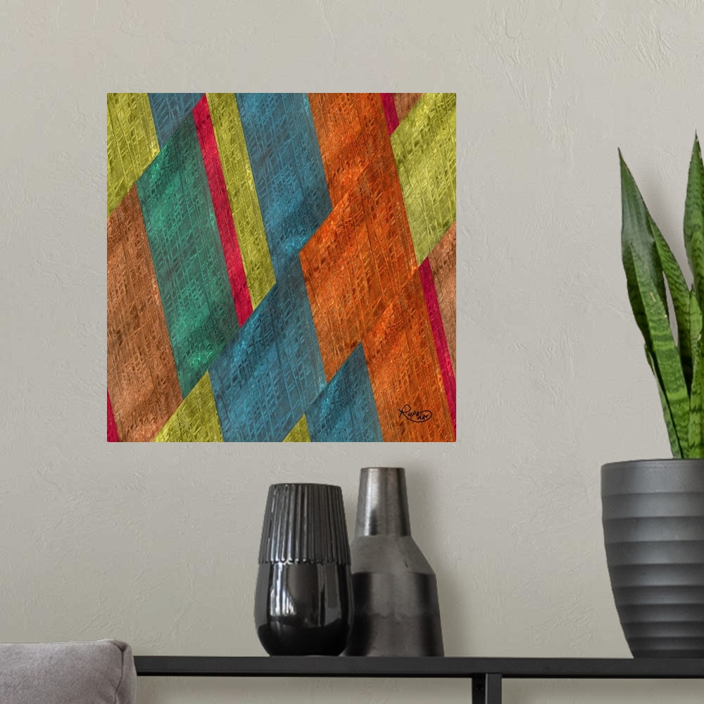 A modern room featuring Square abstract artwork in shades of orange, blue and green in a diagonal striped design.