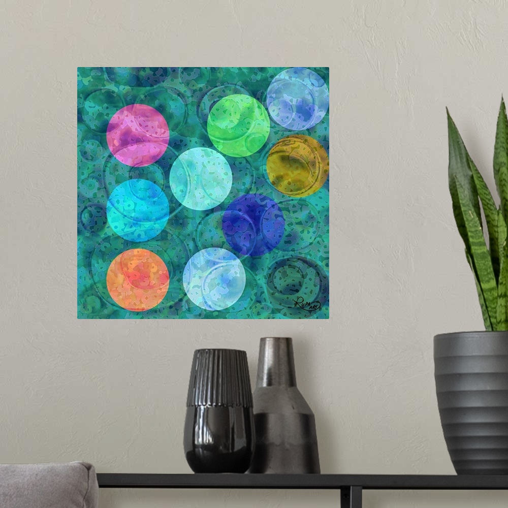 A modern room featuring Square abstract art with colorful circular shapes on top of a blue and green background.