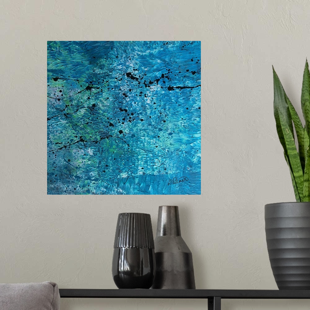 A modern room featuring Square abstract painting with a blue, white, and green textured background with black paint splat...