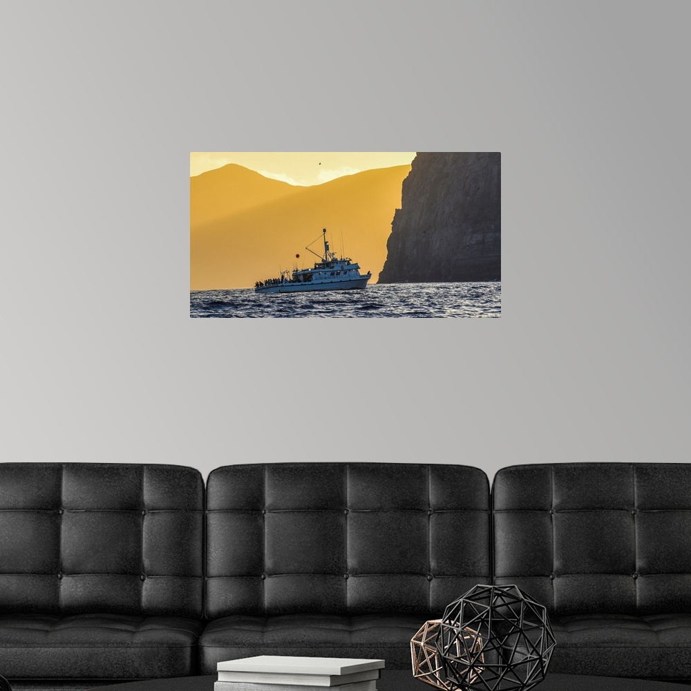 A modern room featuring Guadalupe Island, Mexico. The Royal Polaris fishes in tight at sunset near Guadalupe island, Mexico.