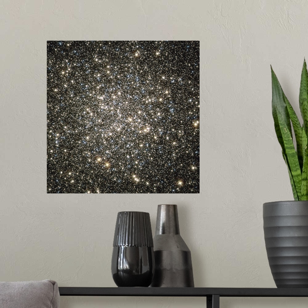 A modern room featuring Square, oversized wall picture of packed together stars in Globular cluster M13, the blackness of...