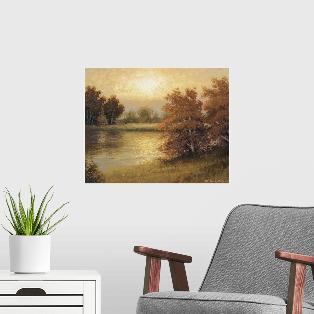 A modern room featuring Horizontal painting on big wall hanging of autumn colored trees surrounding a pond, the landscape...