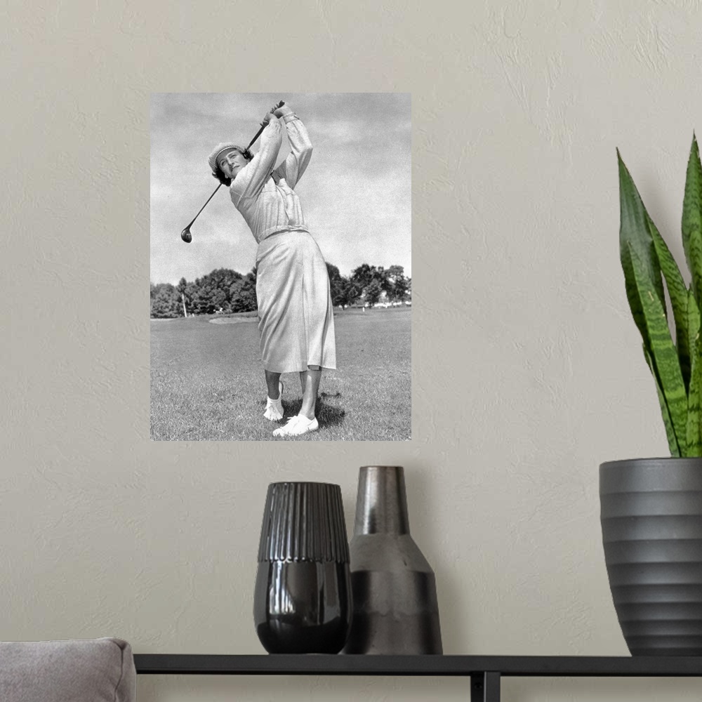 A modern room featuring (1911-1956). Ne Mildred Ella Didrikson. American athlete. Photographed while swinging a golf club...
