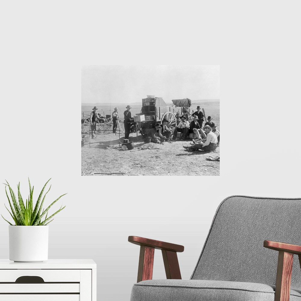 A modern room featuring Cowboy Camp, C1900. A Group Of Cowboys Sitting And Standing Beside A Chuckwagon At A Campsite Nea...
