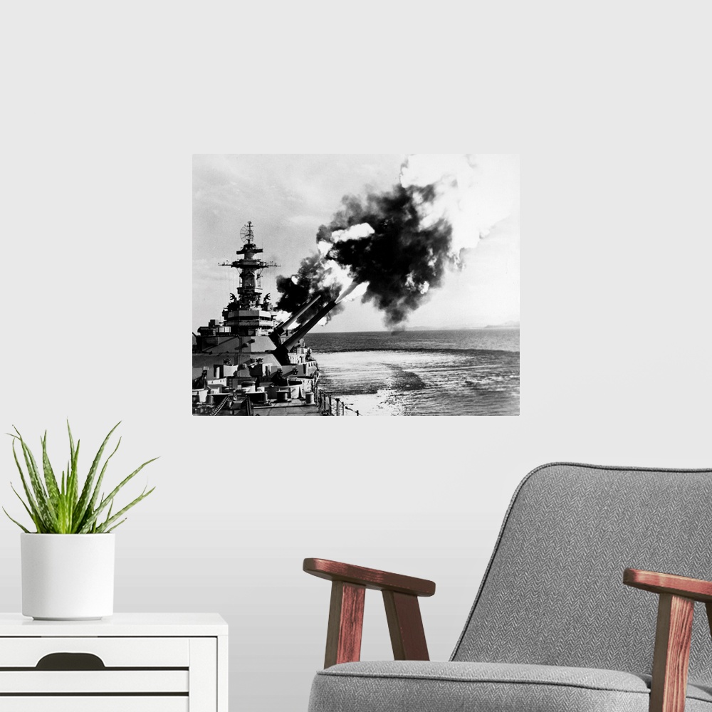 A modern room featuring An American battleship firing its guns during World War II.