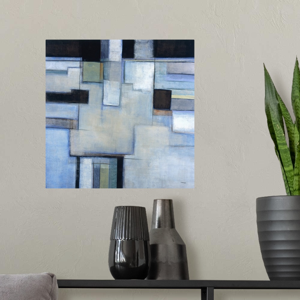 A modern room featuring A square abstract painting with square shapes in shades of blue.