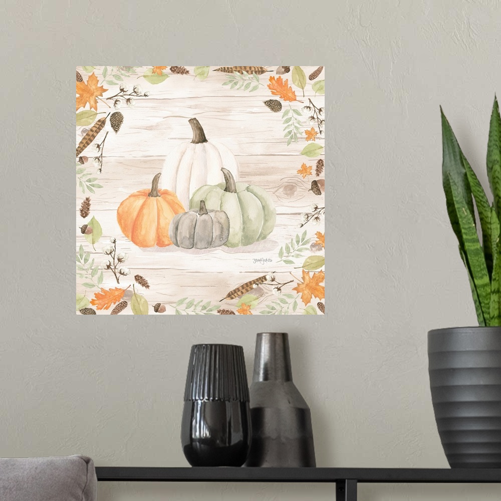 A modern room featuring Decorative artwork of fall leaves framing a group of pumpkins and a white wood background.