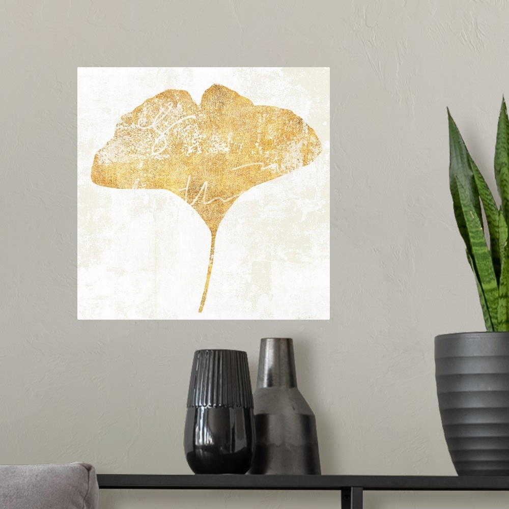 A modern room featuring Gold silhouette of a leaf with white writing.