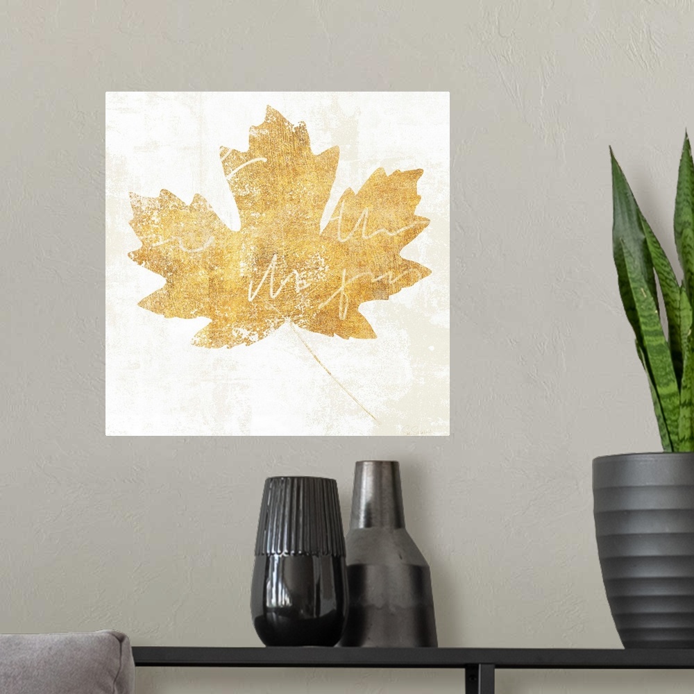 A modern room featuring Gold silhouette of a leaf with white writing.