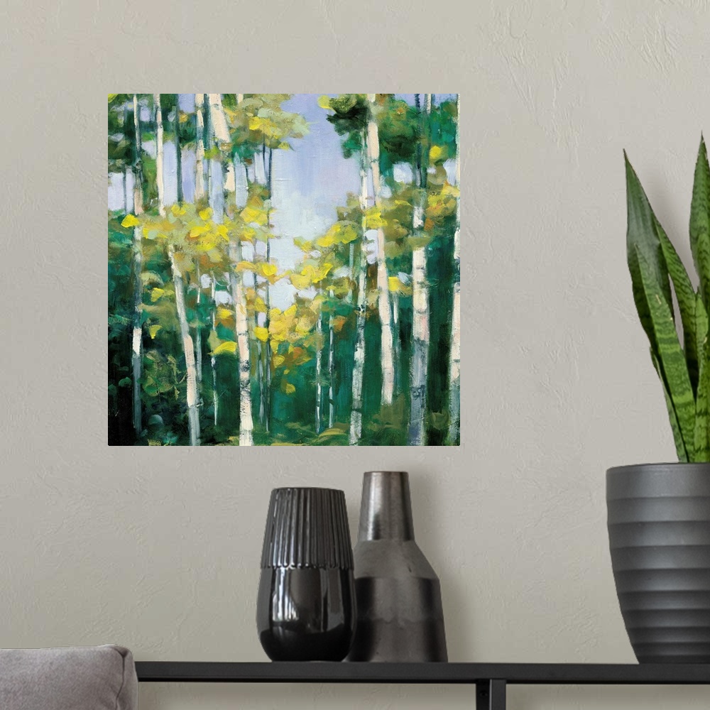 A modern room featuring Contemporary artwork of a forest of birch trees with green leaves.