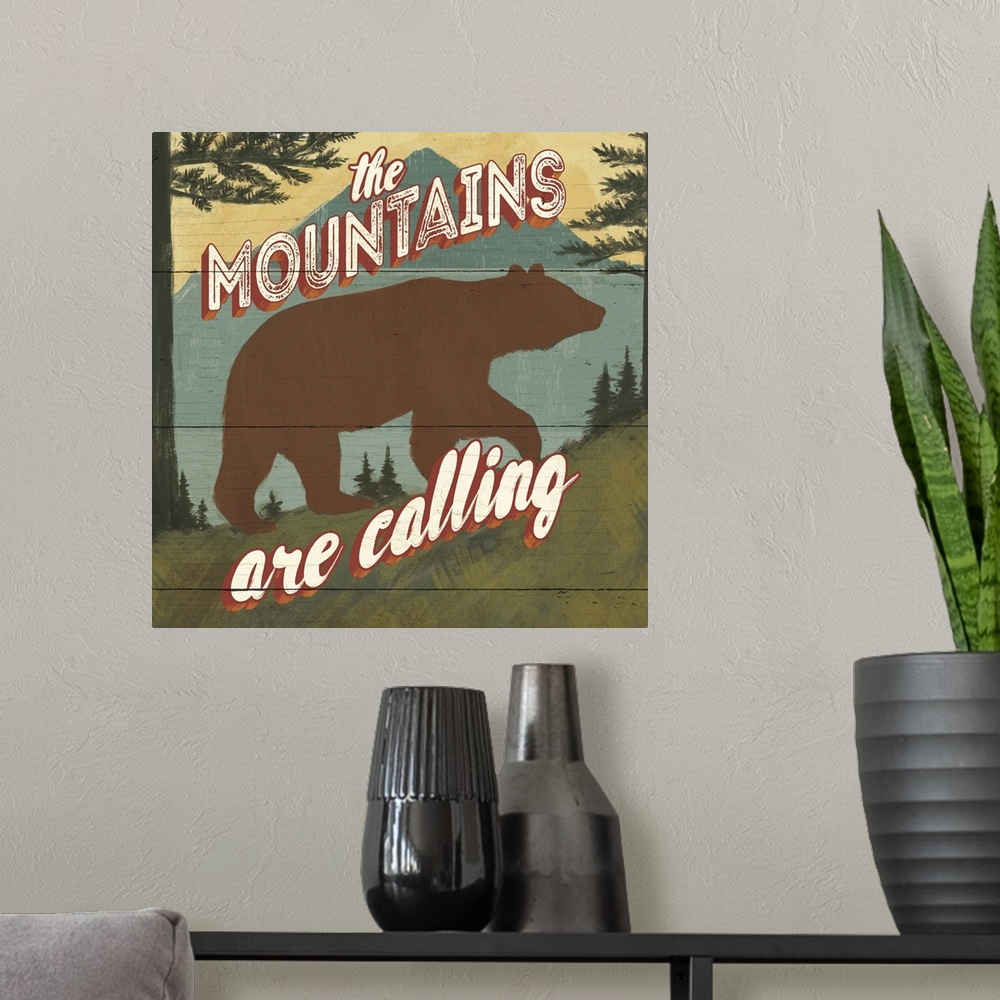 A modern room featuring "The mountains are calling" over a minimalist image of a bear in the wilderness.