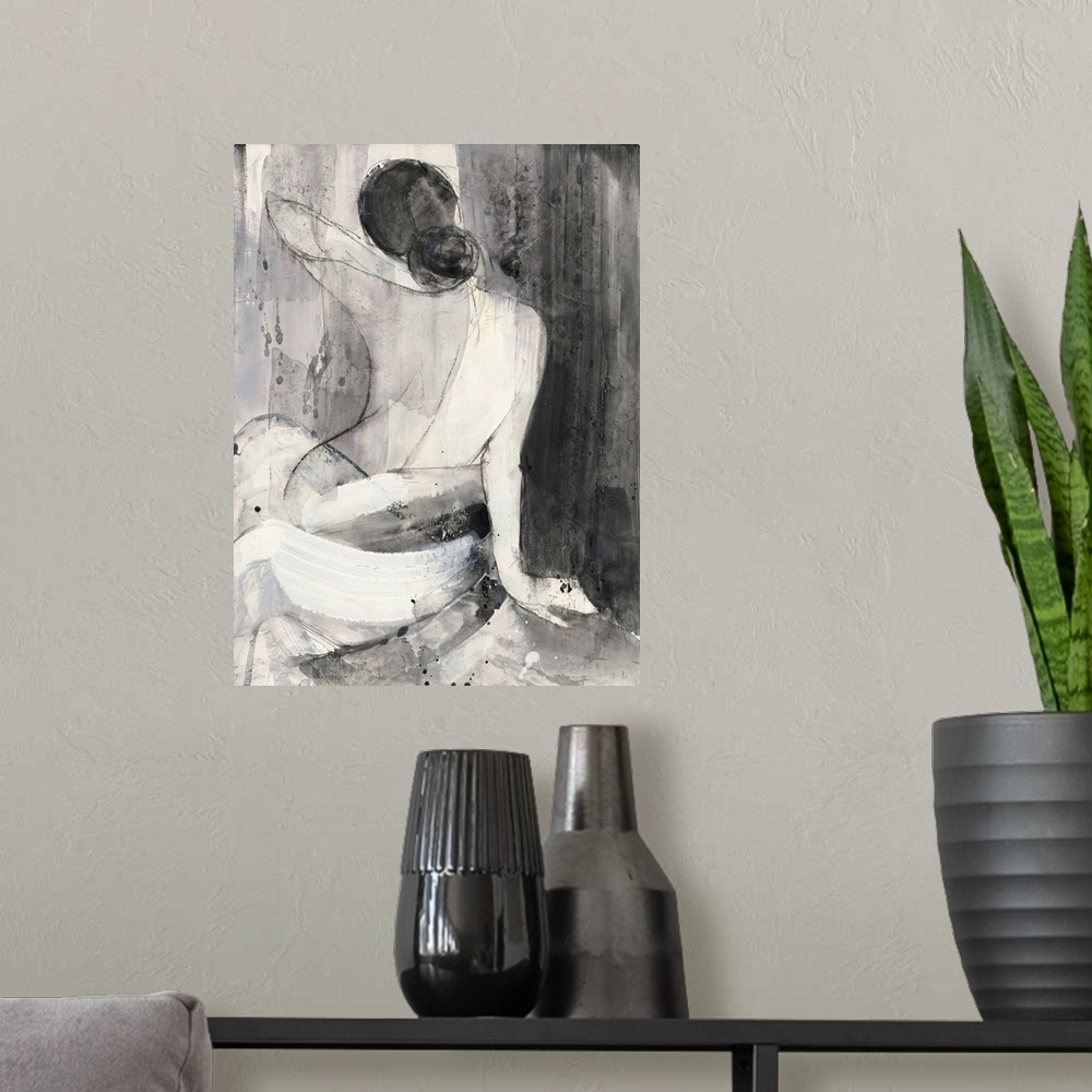 A modern room featuring A painting of the back of a nude woman wrapped in a white cloth done in black and white.