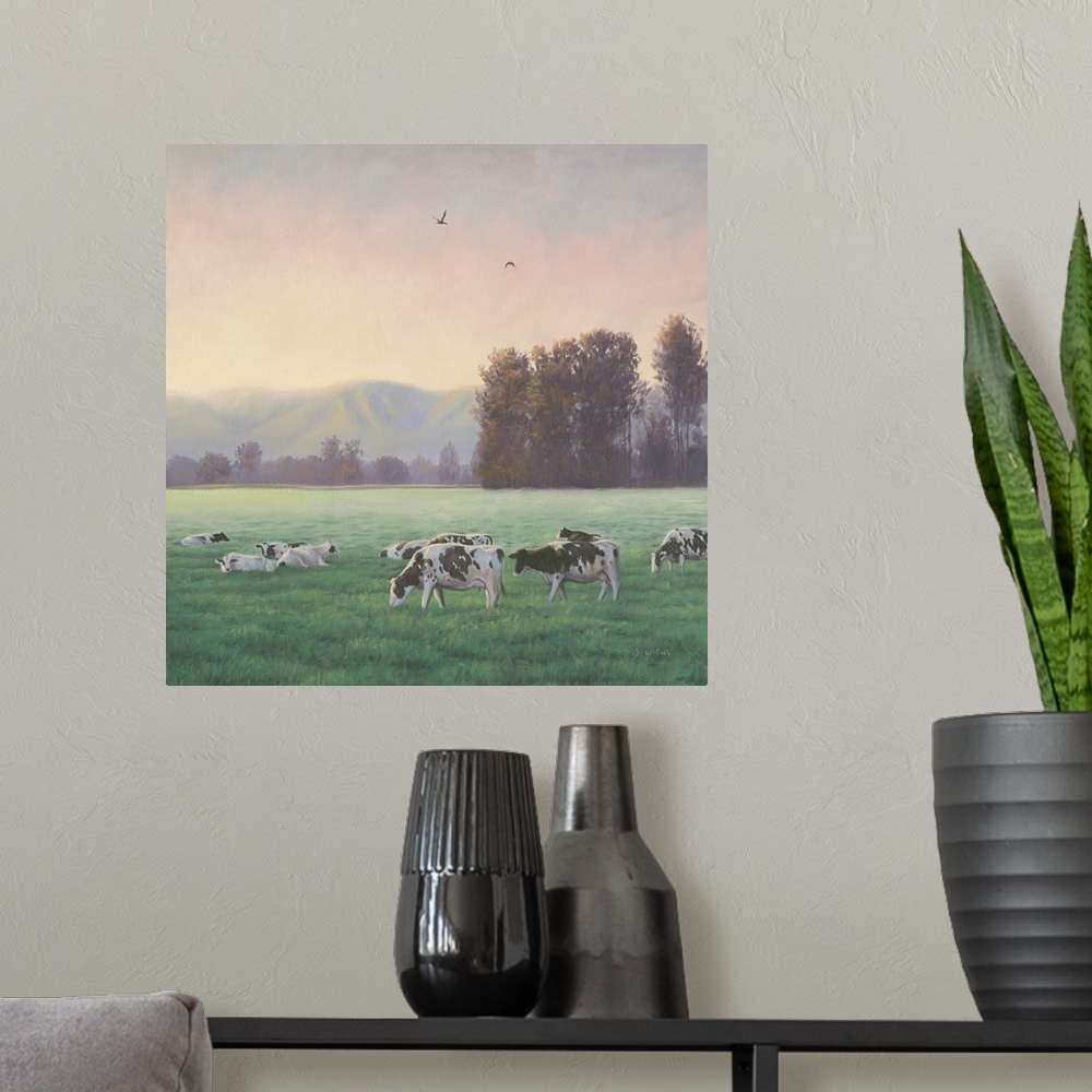 A modern room featuring Square painting of a rural farm scene with grazing cows and mountains in the background.