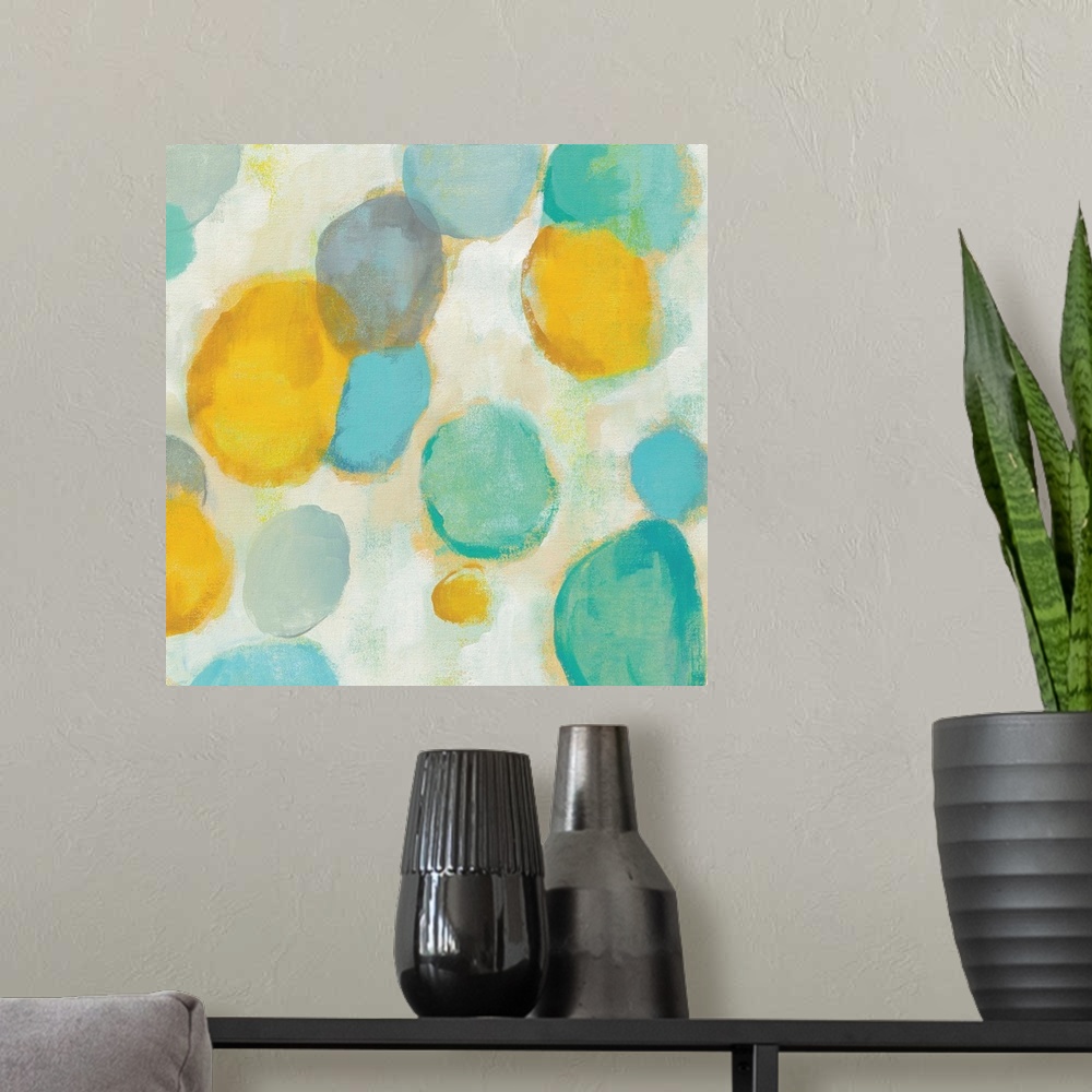 A modern room featuring Abstract artwork of bright circle shapes in yellow and teal.