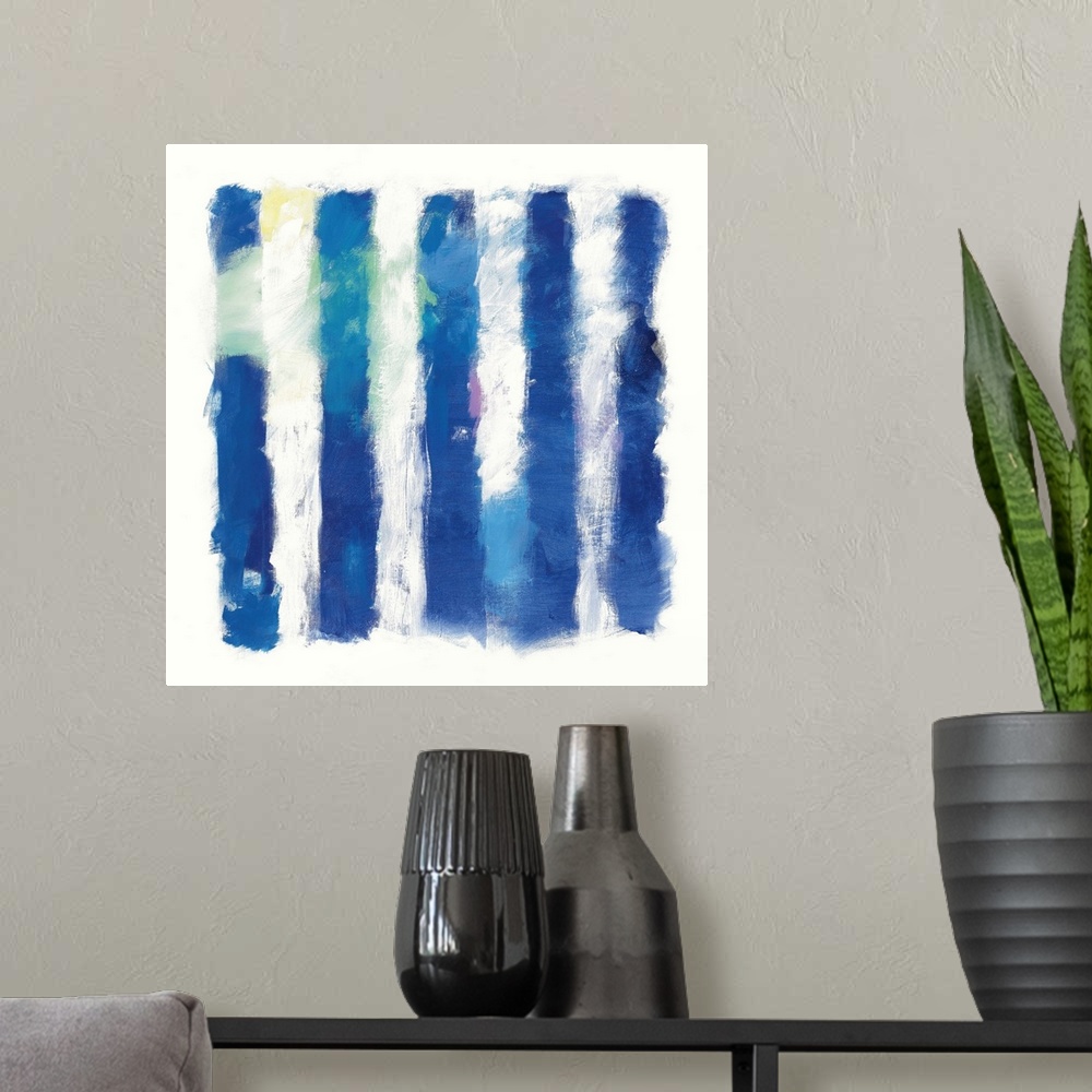 A modern room featuring Abstract art of deep blue vertical stripes on white.