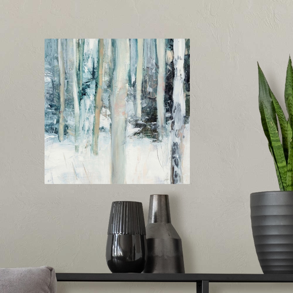 A modern room featuring Square abstract painting of birch trees in the woods covered in snow with cool tones.