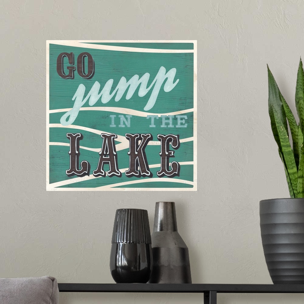 A modern room featuring Decorative sign for a cabin or lodge that reads "Go Jump In The Lake."